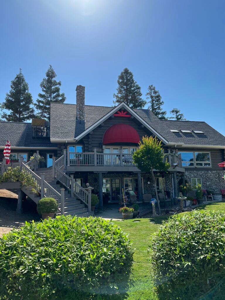 Two-story home with a deck and landscaping after exterior cleaning