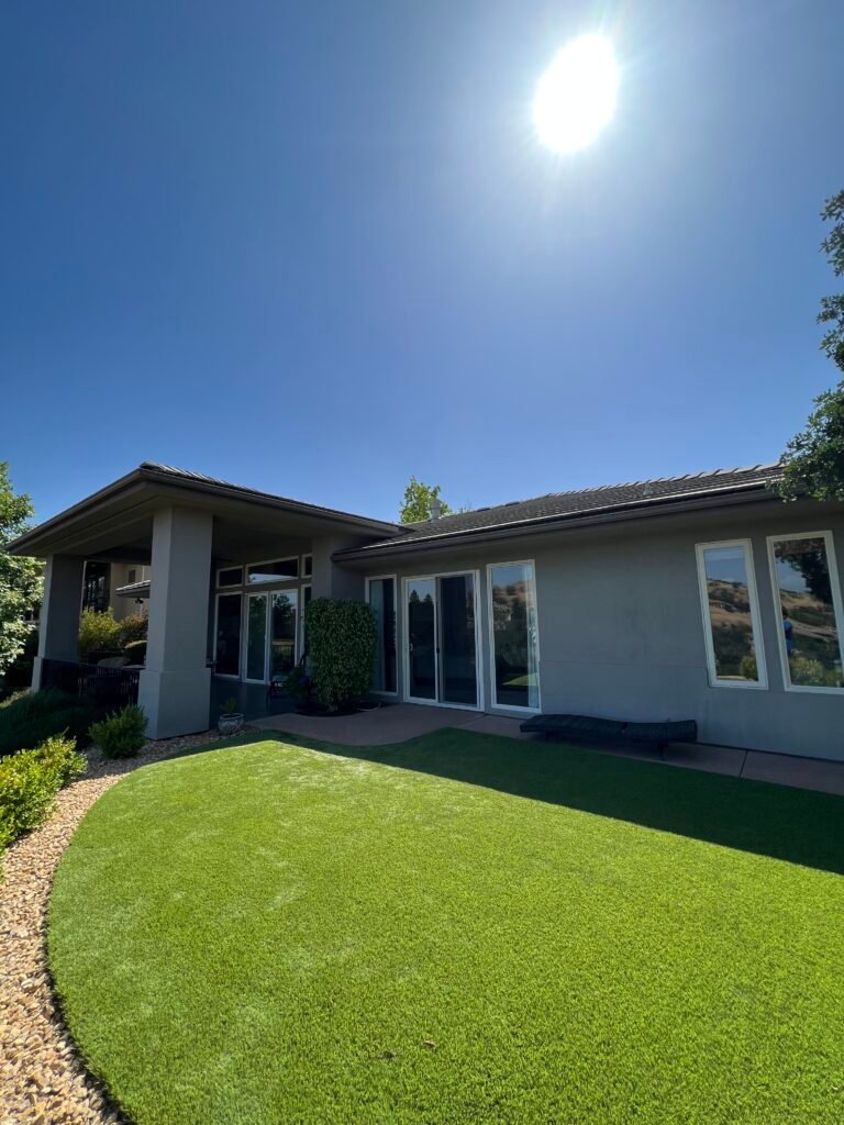 Single-story home exterior and lawn after cleaning