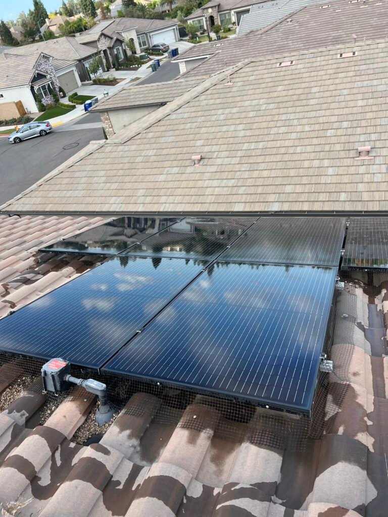 Clean rooftop solar panels on a concrete tile roof in the Fresno area