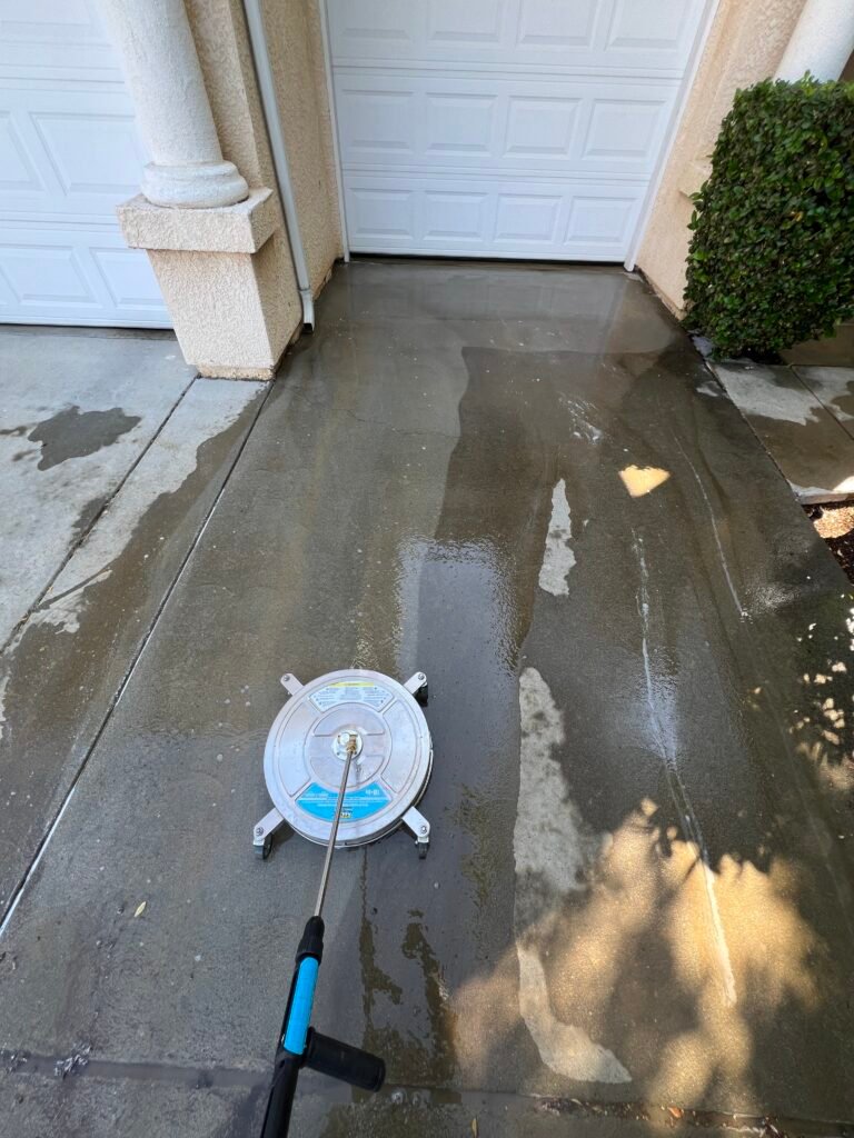 Surface cleaner pressure washing a concrete patio
