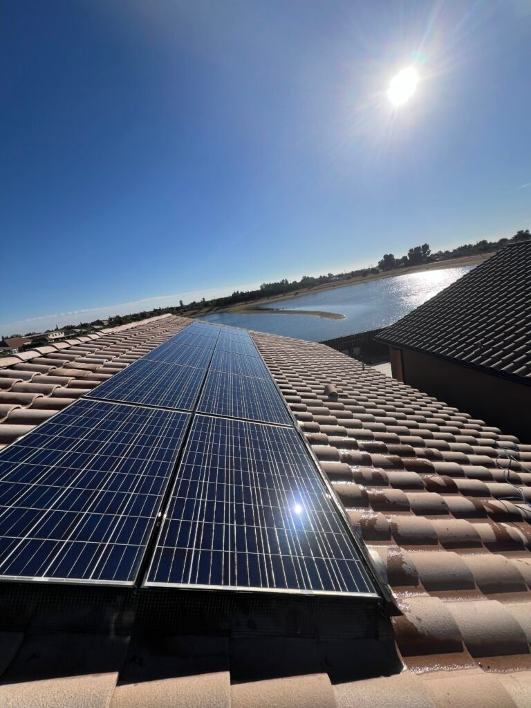 Solar panels mounted on a tan concrete tile roof