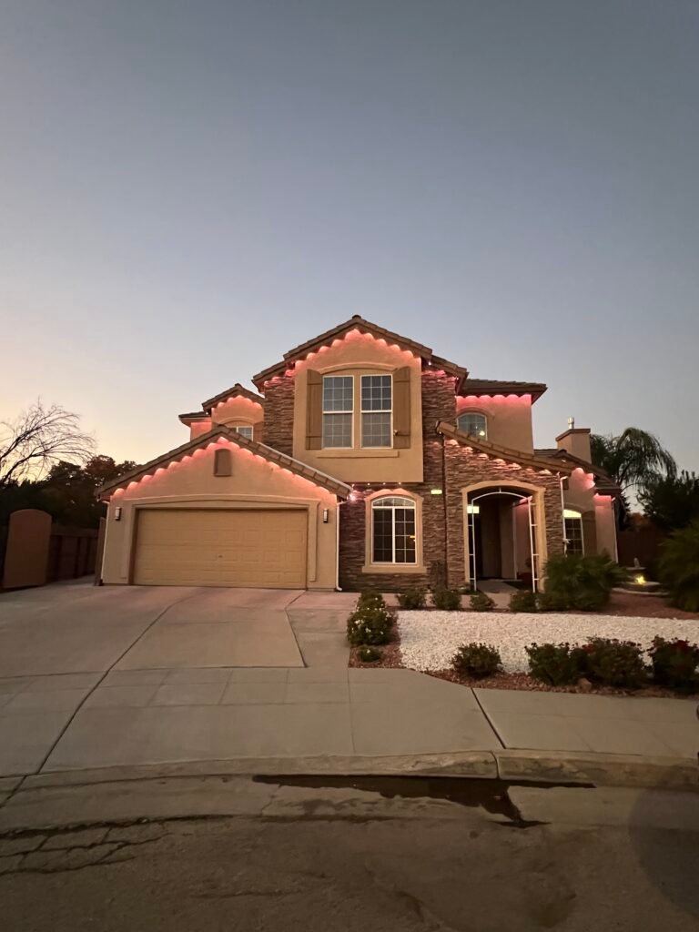 Clean two-story stucco home with a tile roof at dusk in Fresno