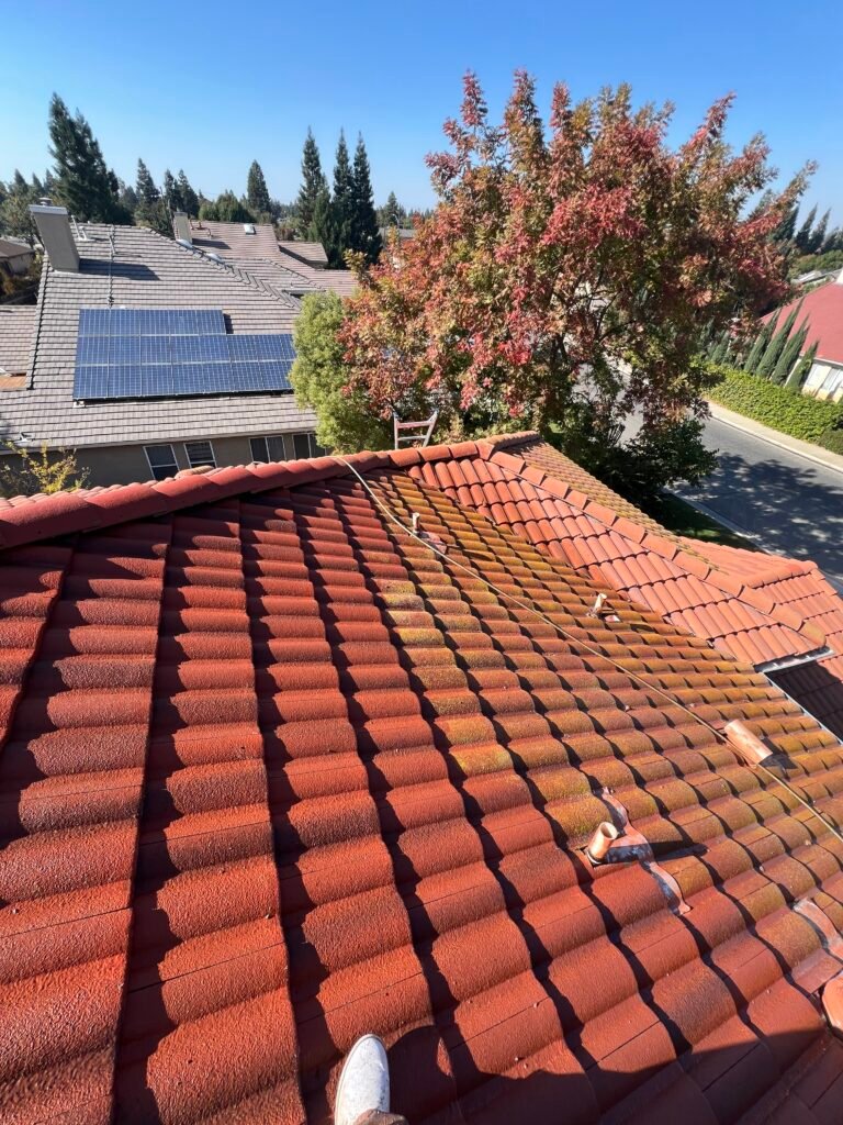 Red clay tile roof with solar panels in the Fresno area